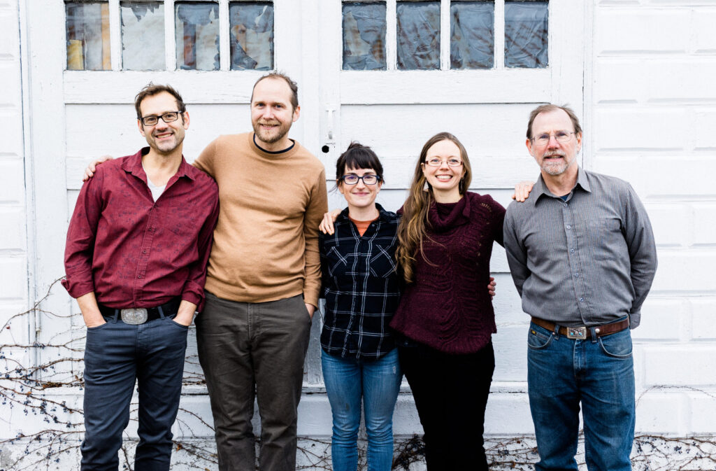 5 founding members of the Regenerative Design Group Coop Board posing outside the office